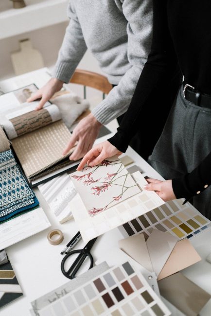 people looking at different fabrics